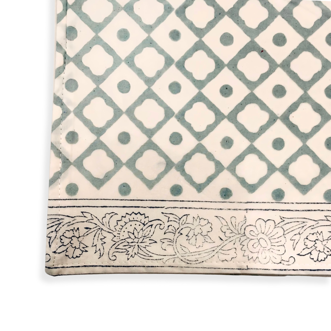 Table cloth with geometric pattern and floral border on a white background