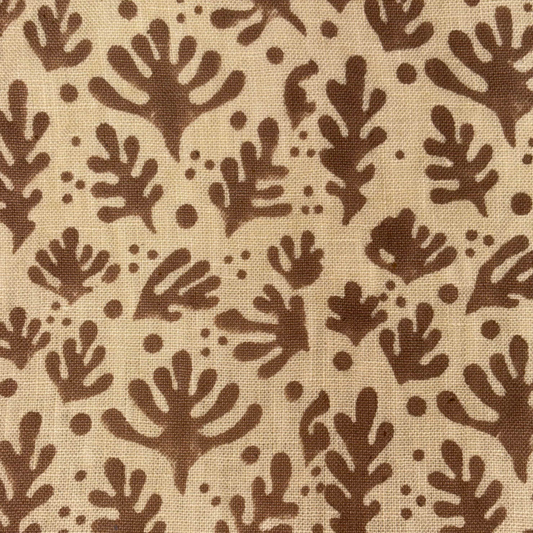 Brown leaf pattern on beige fabric background