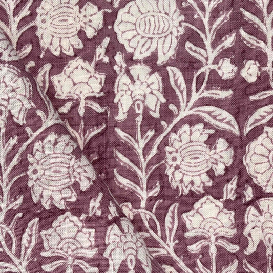 Fabric with white floral pattern on a purple background