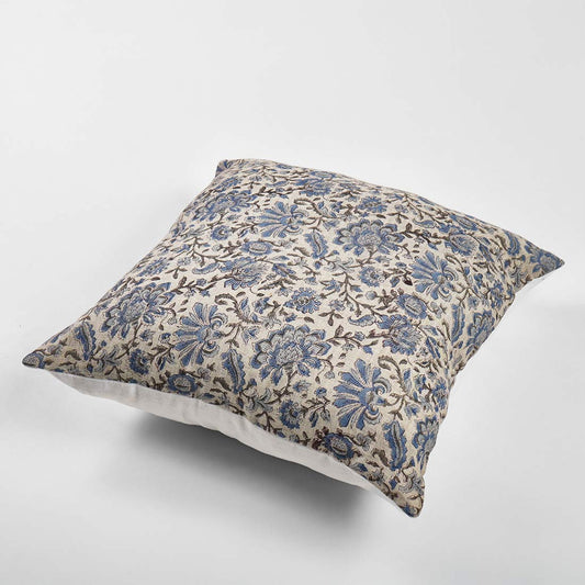Decorative pillow with blue floral pattern on a white background