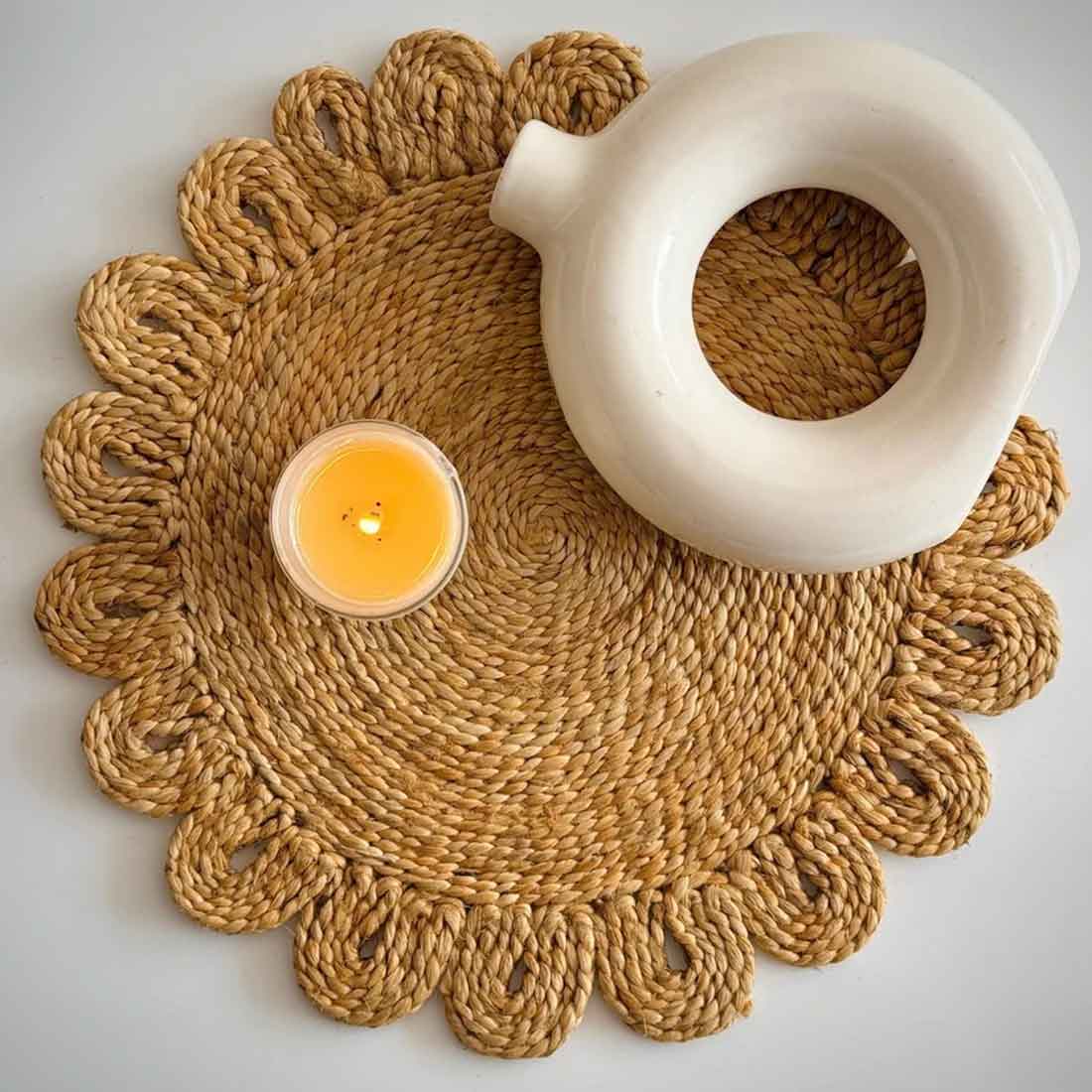 Woven placemat with a candle and ceramic item on a light background