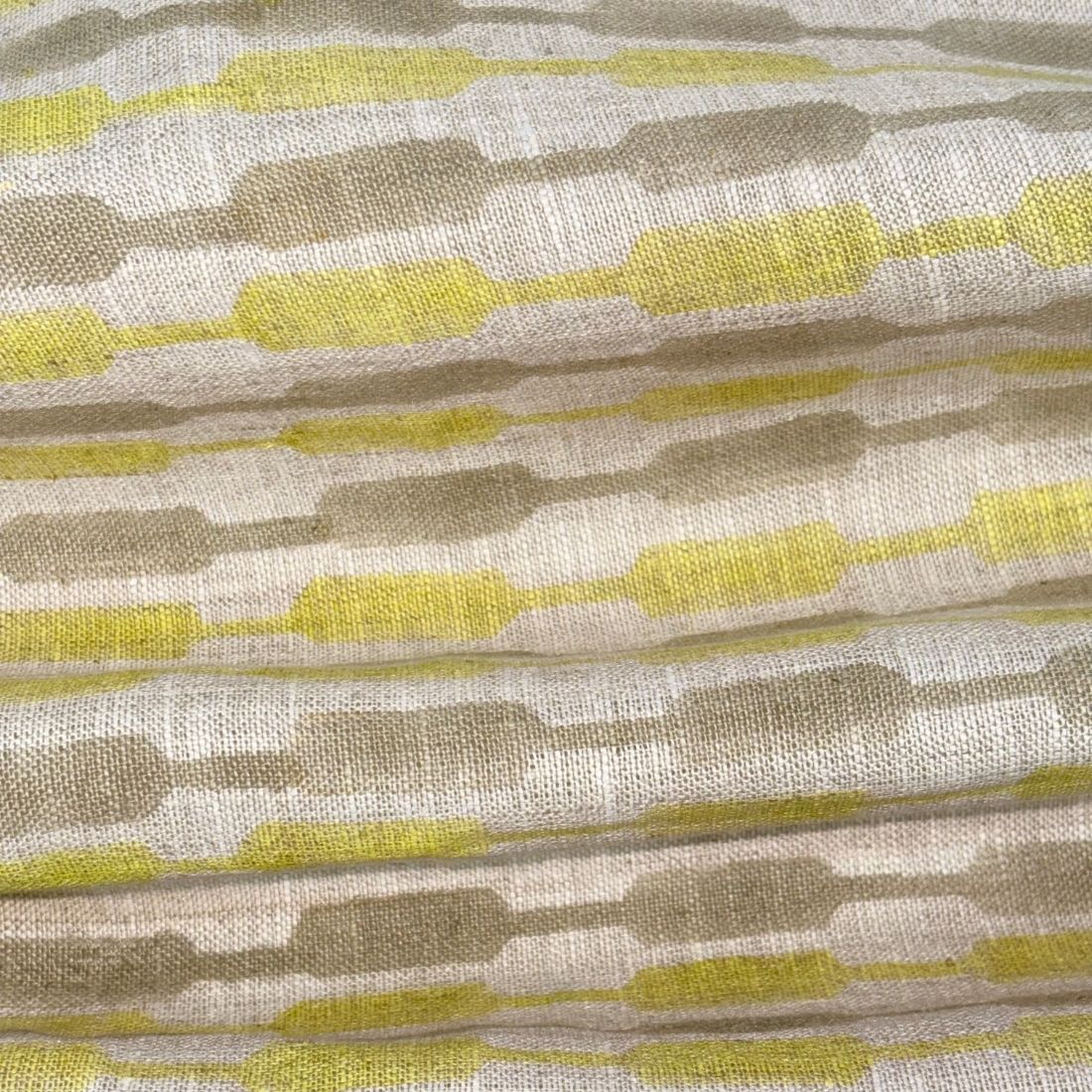 Textile fabric with a geometric pattern in brown, yellow, and grey.