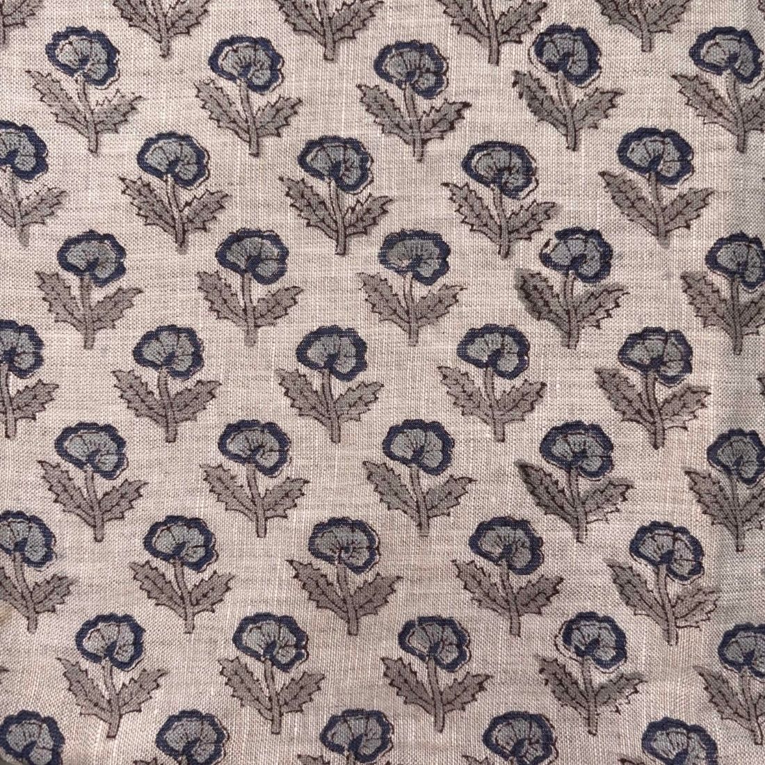 Patterned fabric with blue floral design on beige background