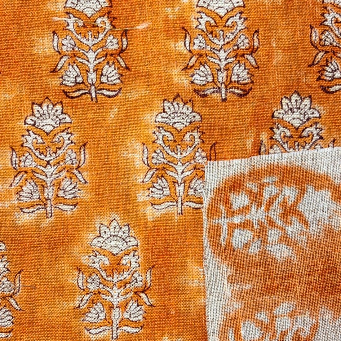 Orange fabric with white floral patterns