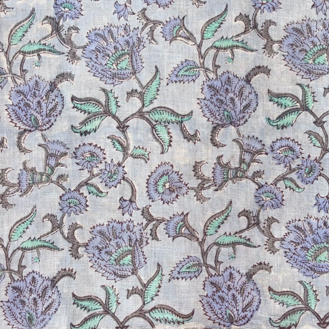 Floral pattern with purple and green flowers on a light gray background