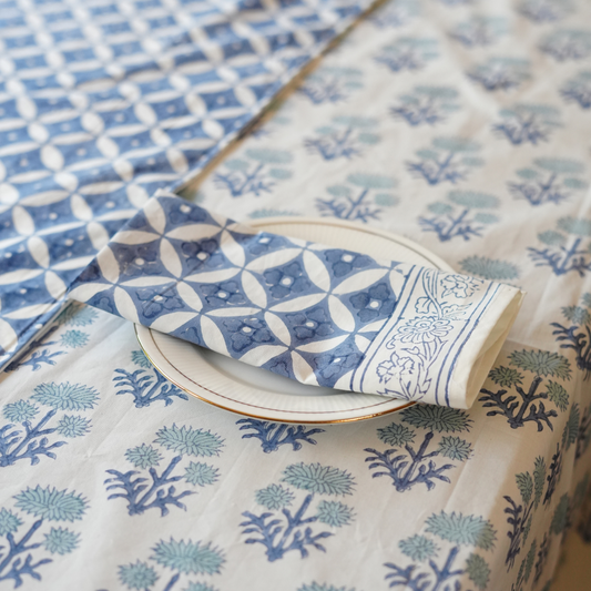 Patterned table linen set with geometric and floral designs on a table.