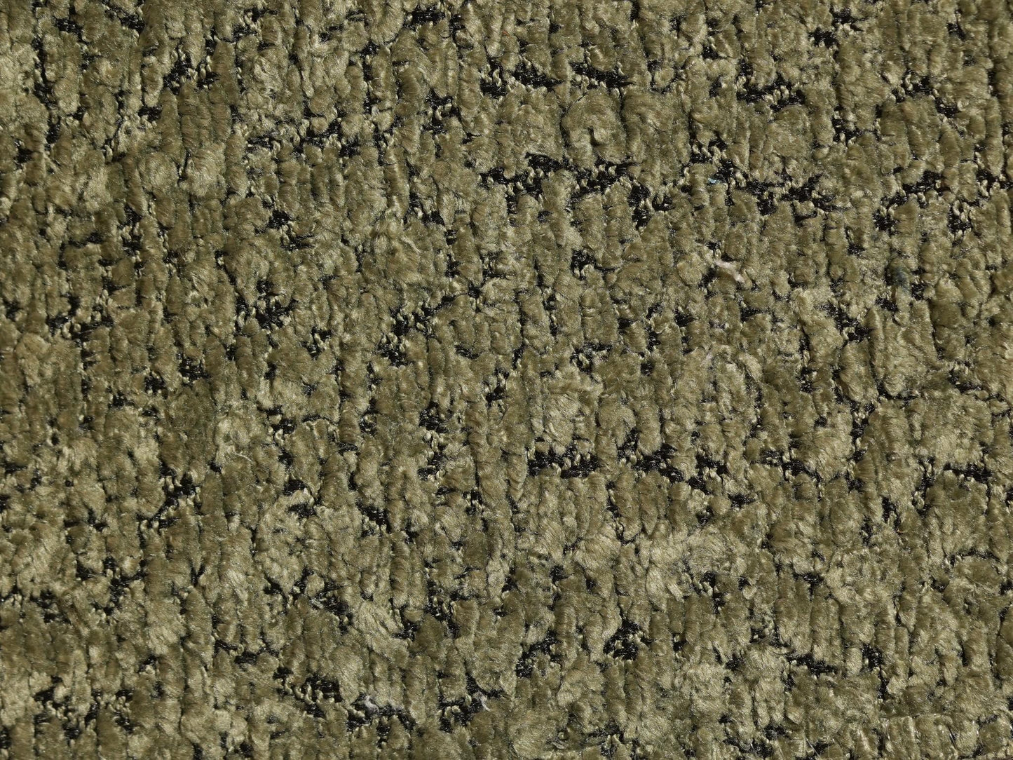 Textured green carpet with black specks