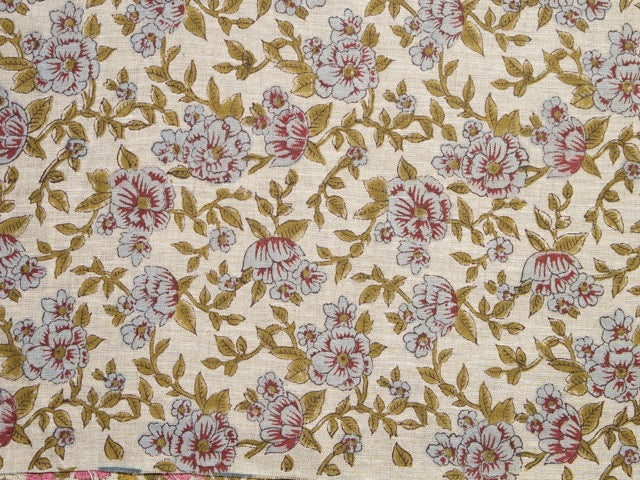 Floral patterned fabric with pink and green flowers on a beige background