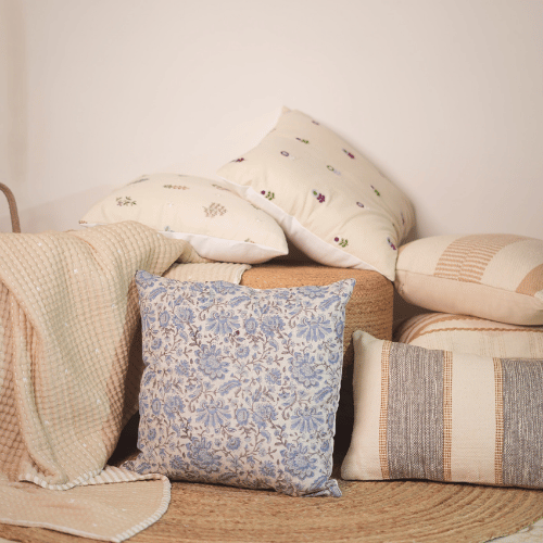 Decorative pillows with floral patterns on a textured surface