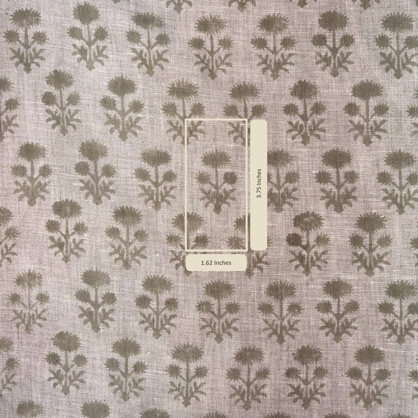 Fabric with a floral pattern and a ruler for scale on a gray background
