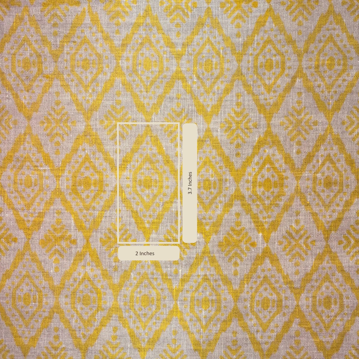 Fabric with yellow and grey diamond pattern and a ruler for scale.