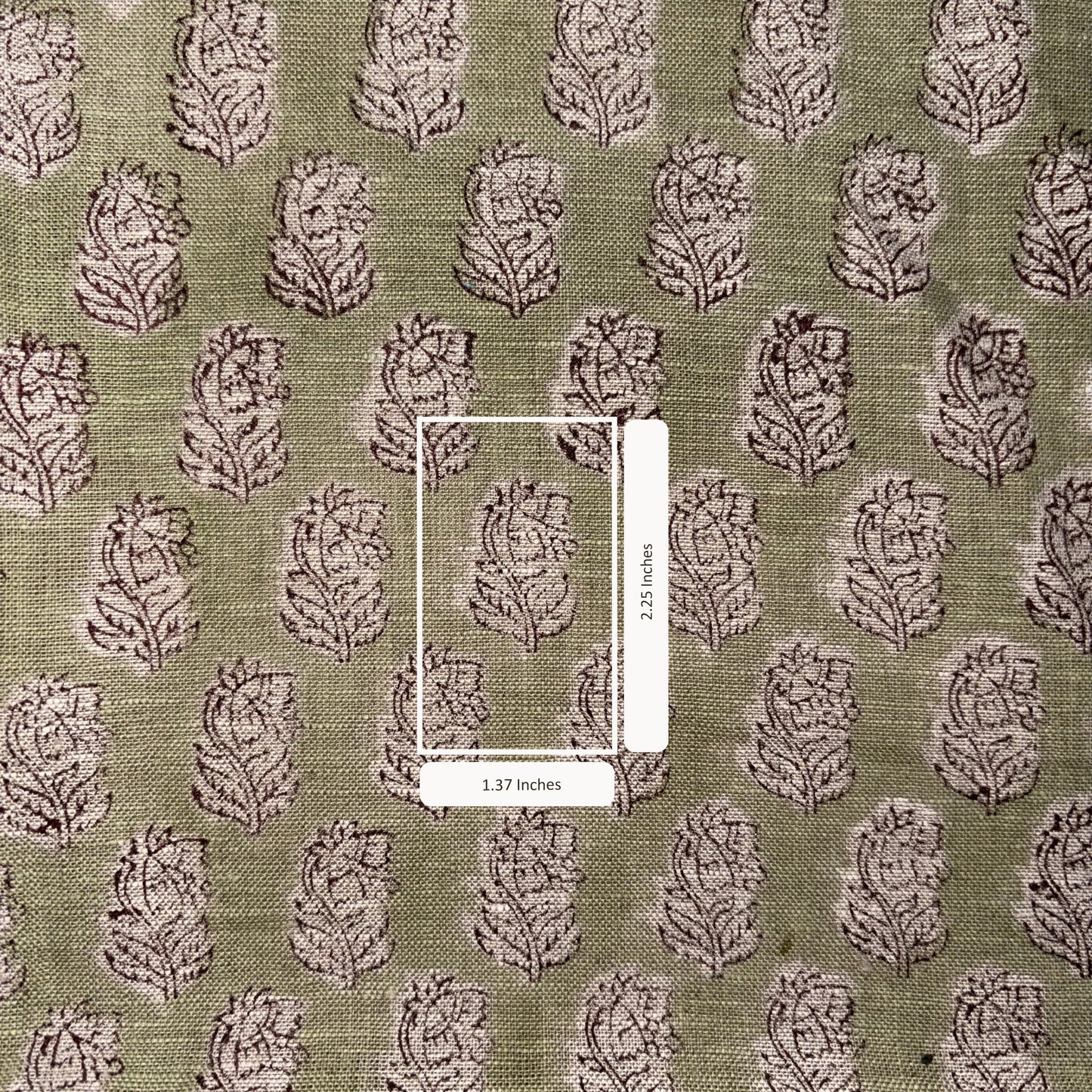 Patterned fabric with a scale bar indicating dimensions on a green background