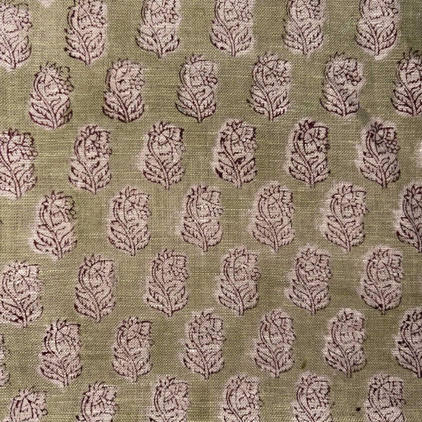 Patterned fabric with leaf design on a green background