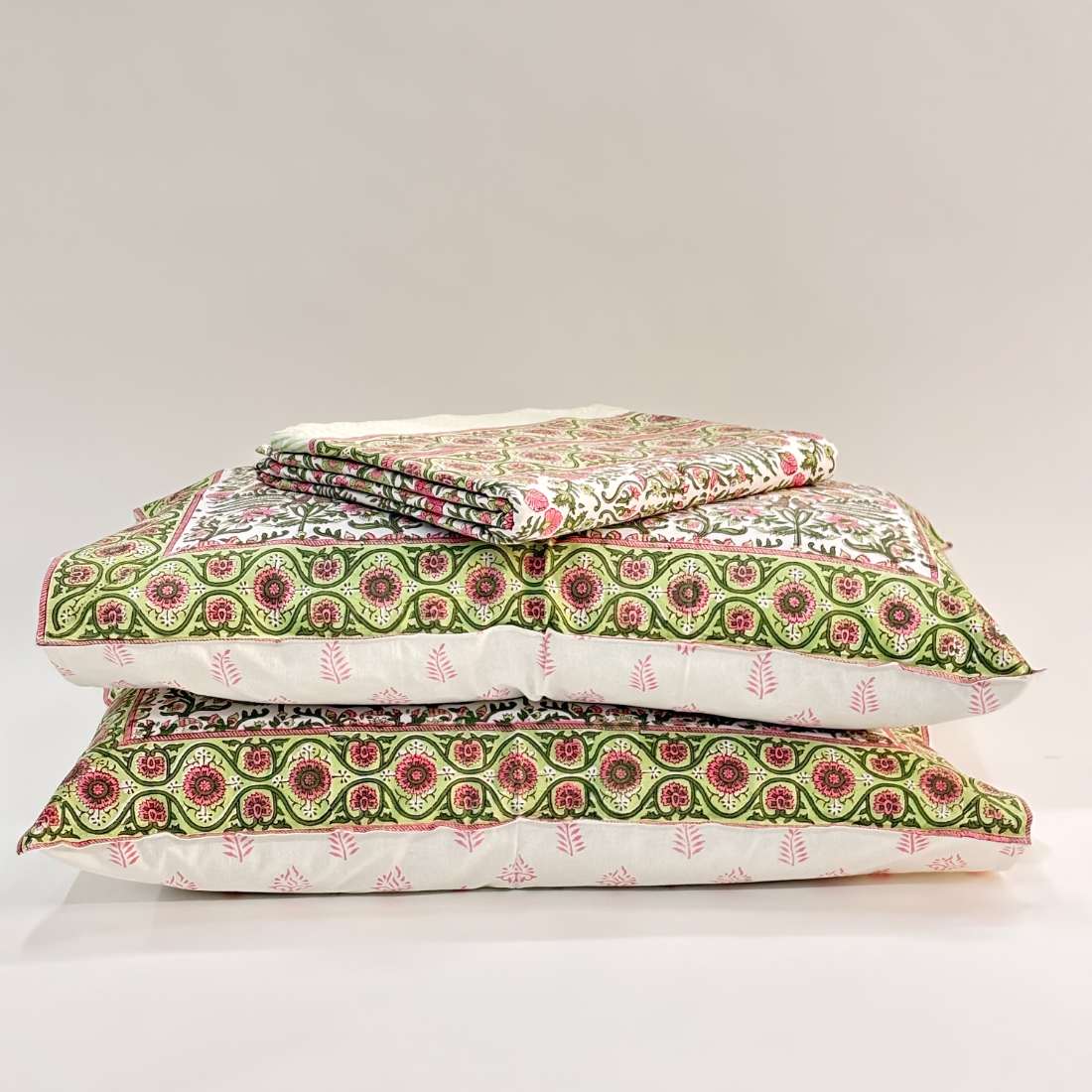 Stack of patterned pillows on a light gray background
