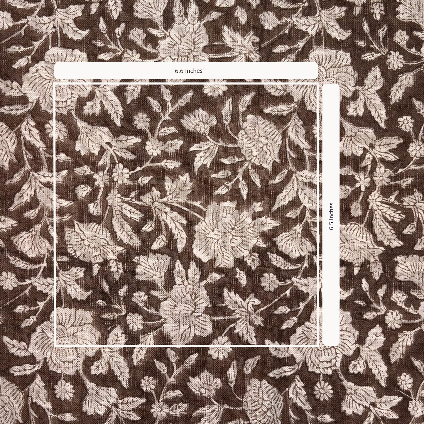 Floral patterned fabric with a measurement overlay on a brown background