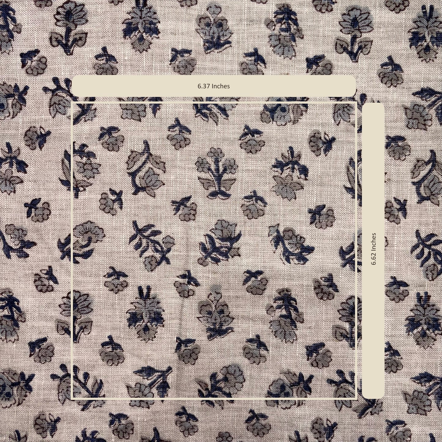 Floral patterned fabric with a ruler for scale on a beige background