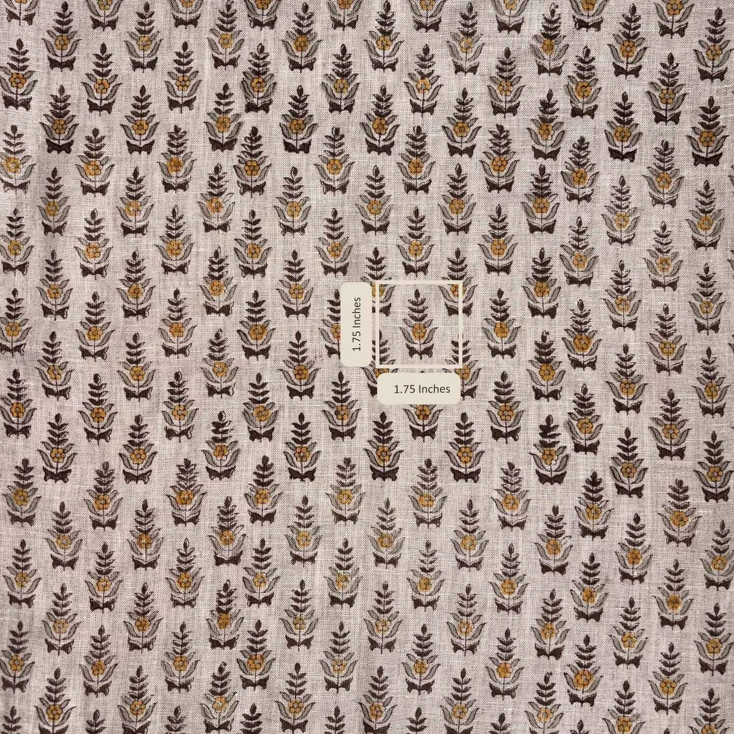 Fabric with a pattern of small leaf-like shapes on a neutral background, with a label indicating fabric dimensions.