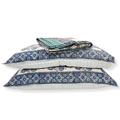 Set of blue and white patterned pillows on a white background