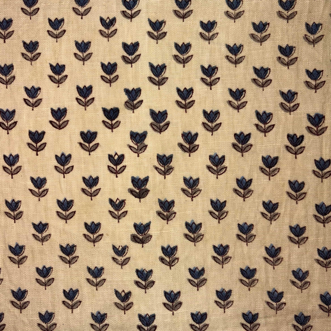 Pattern of blue flowers on beige fabric