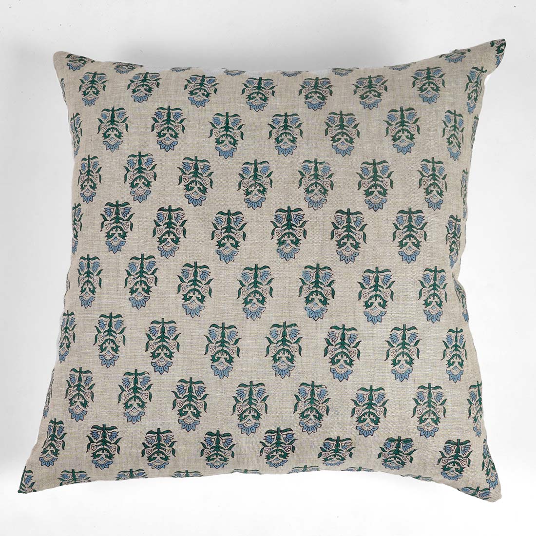 Decorative pillow with a green and blue floral pattern on a white background