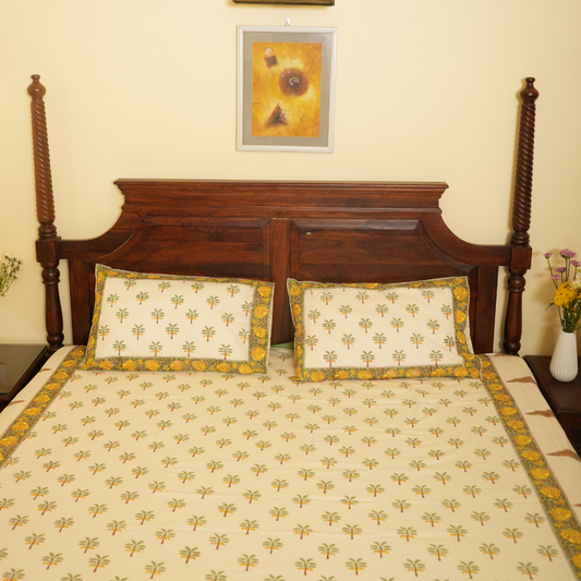 Bed with wooden headboard and floral bedding in a room with a painting on the wall.