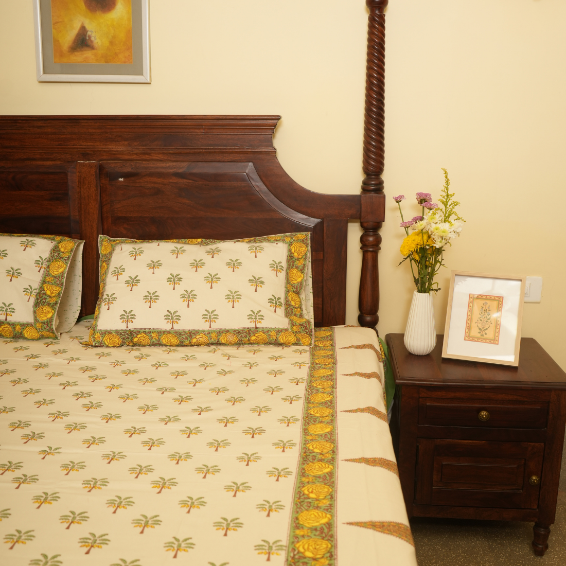 Bedroom with wooden bed and nightstand, featuring floral patterns and decor.