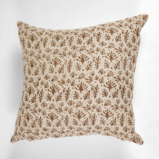 Decorative pillow with brown leaf pattern on a white background