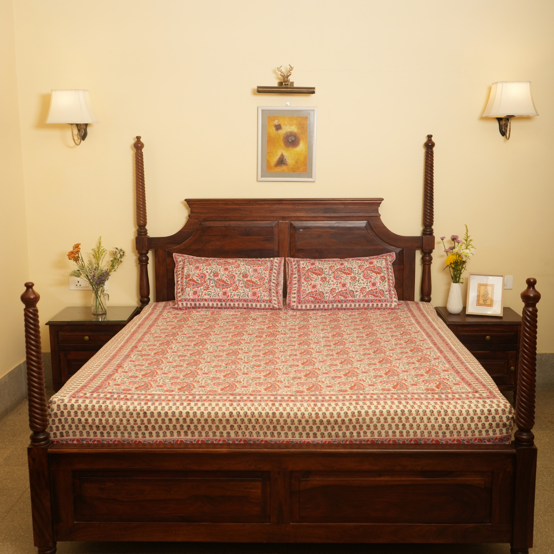 Wooden bed with patterned bedding in a bedroom setting.