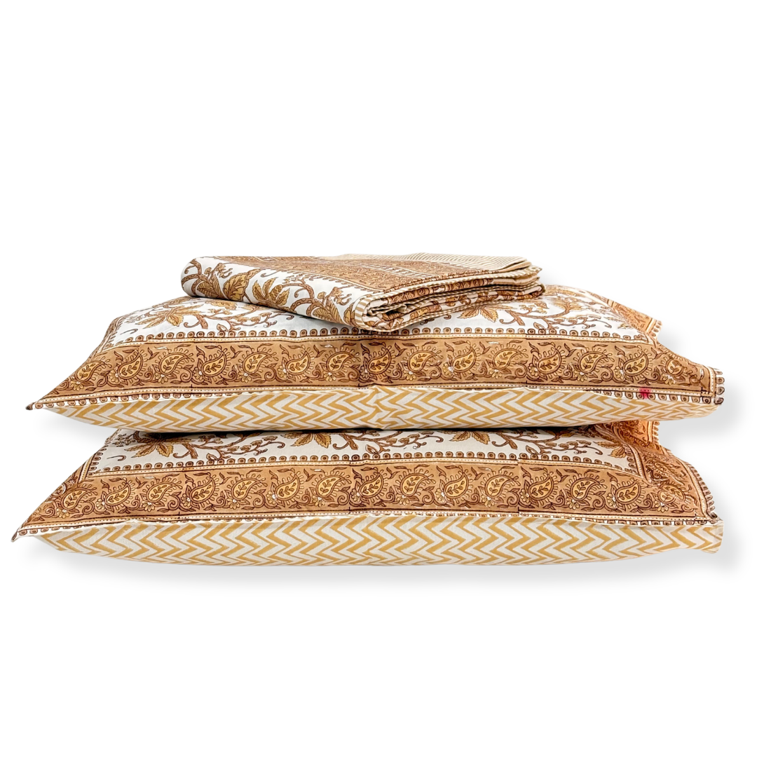Set of patterned pillows and a folded bedsheet on a white background