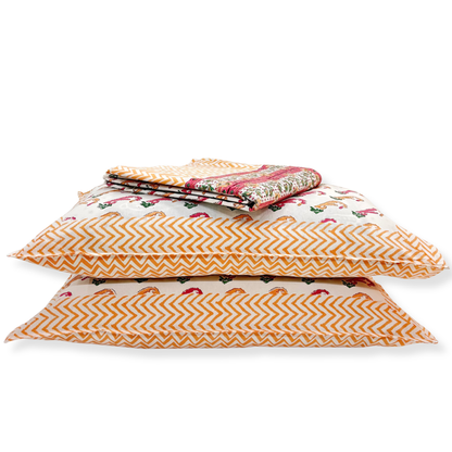 Stack of patterned pillows on a white background