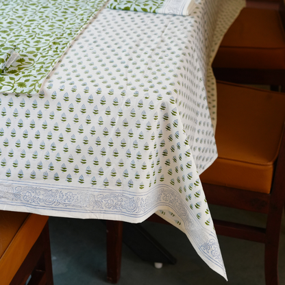 Tablecloth with green and white pattern on a wooden table