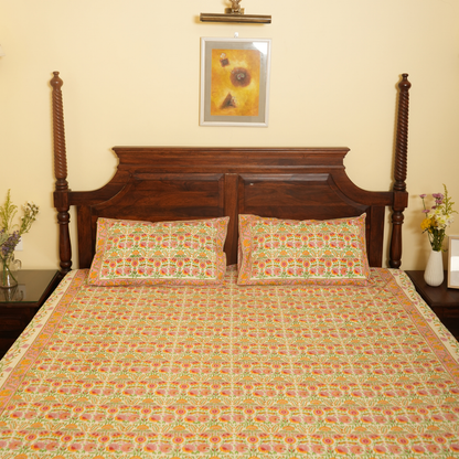 Bed with floral bedding and wooden headboard in a room with a painting on the wall.