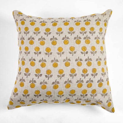 Block printed pillow with yellow floral pattern on a white background