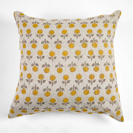 Block printed pillow with yellow floral pattern on a white background