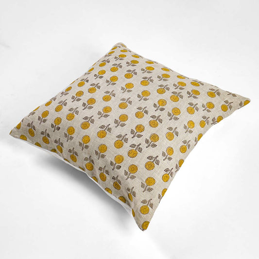 Decorative pillow with yellow floral pattern on a beige background