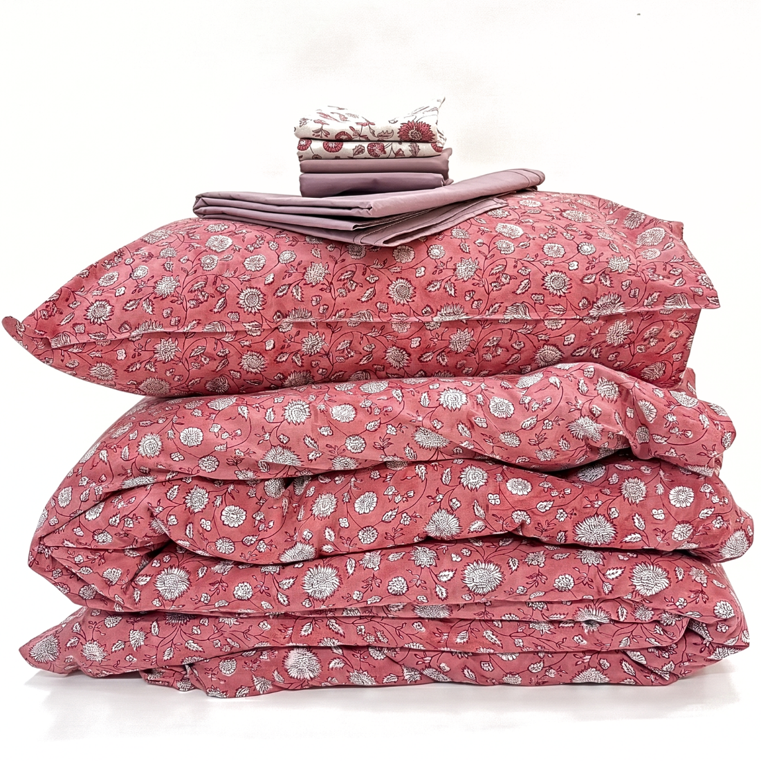 Pink floral duvet set with matching pillowcases on a white background