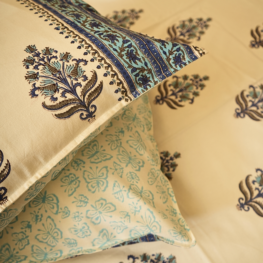 Decorative pillows with intricate patterns on a beige background