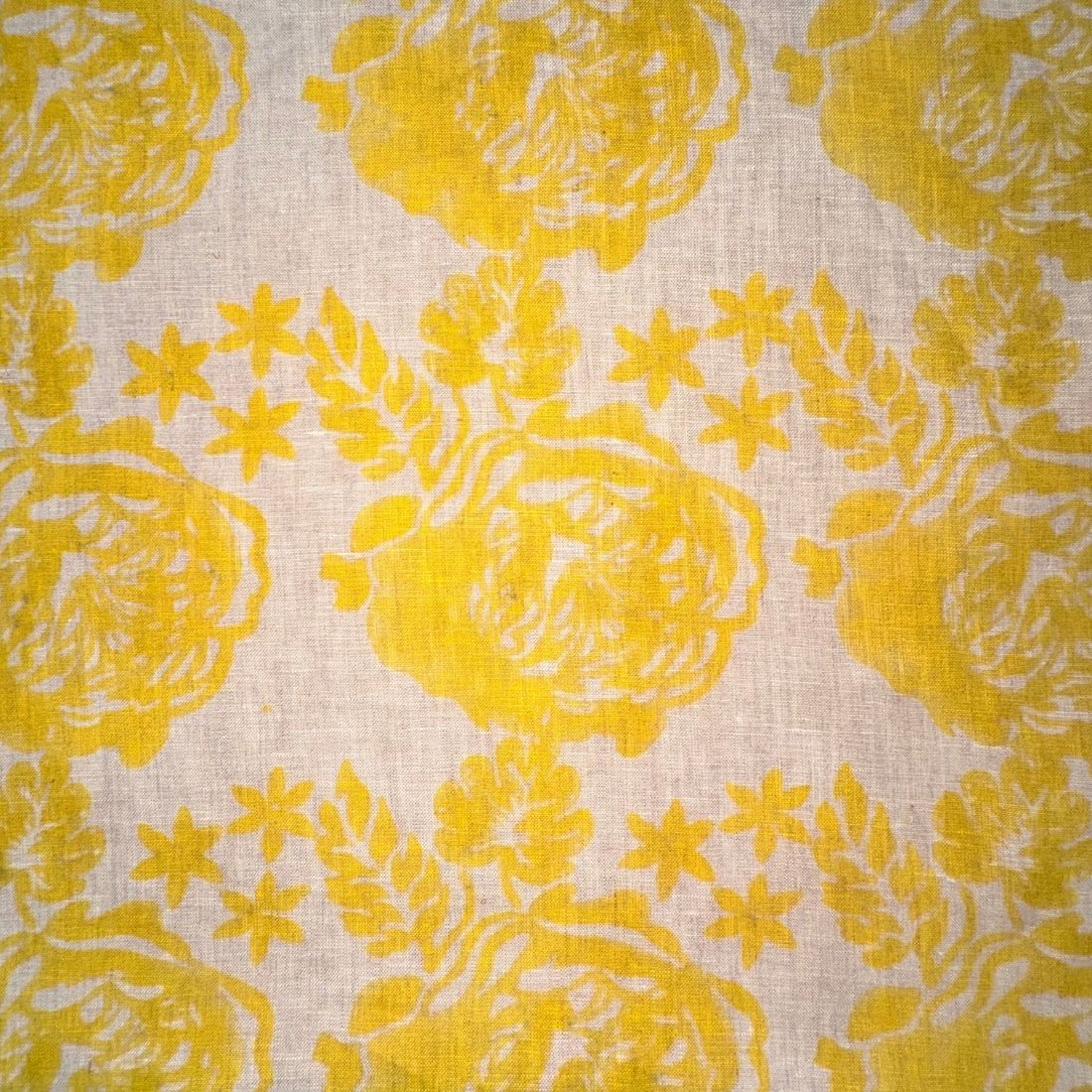 Yellow floral pattern on a beige fabric background