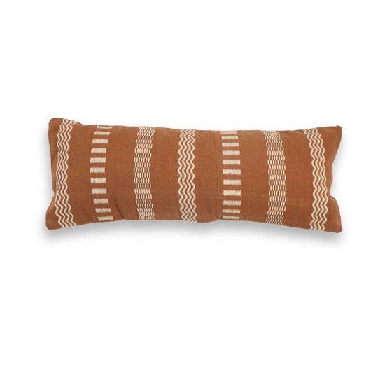 Brown pillow with white geometric patterns on a white background