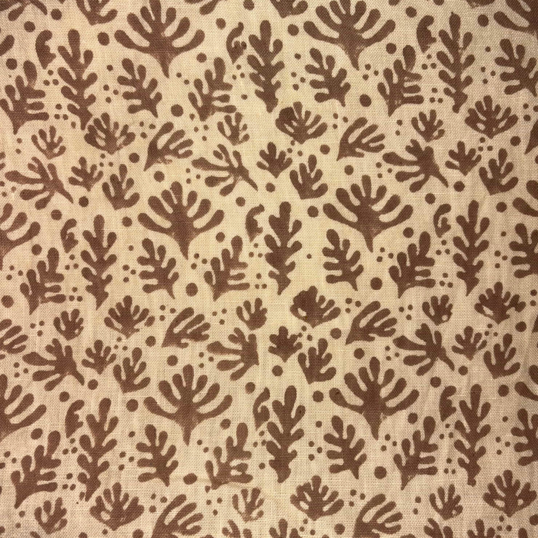 Brown leaf pattern on beige fabric