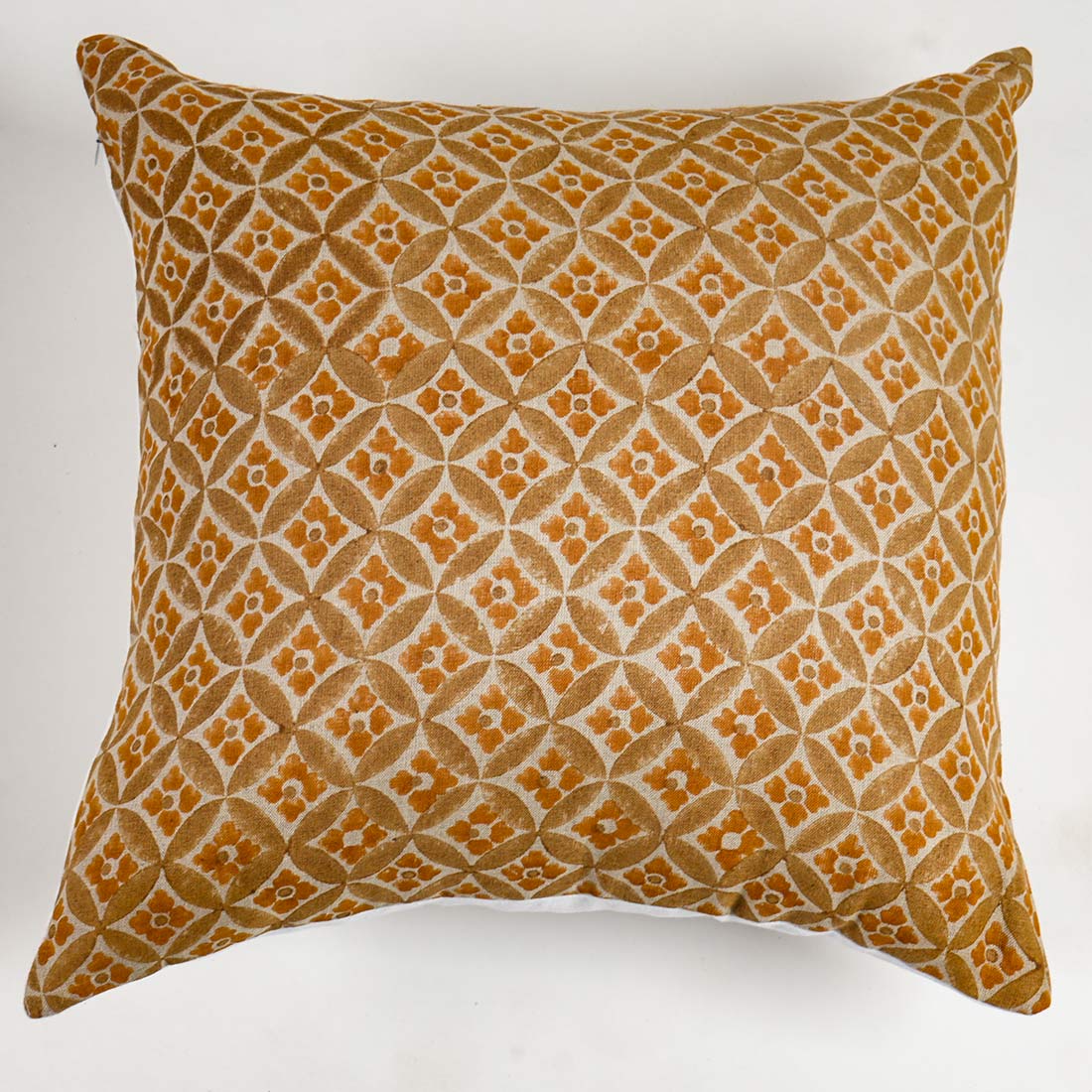 Decorative pillow with geometric pattern on a yellow background