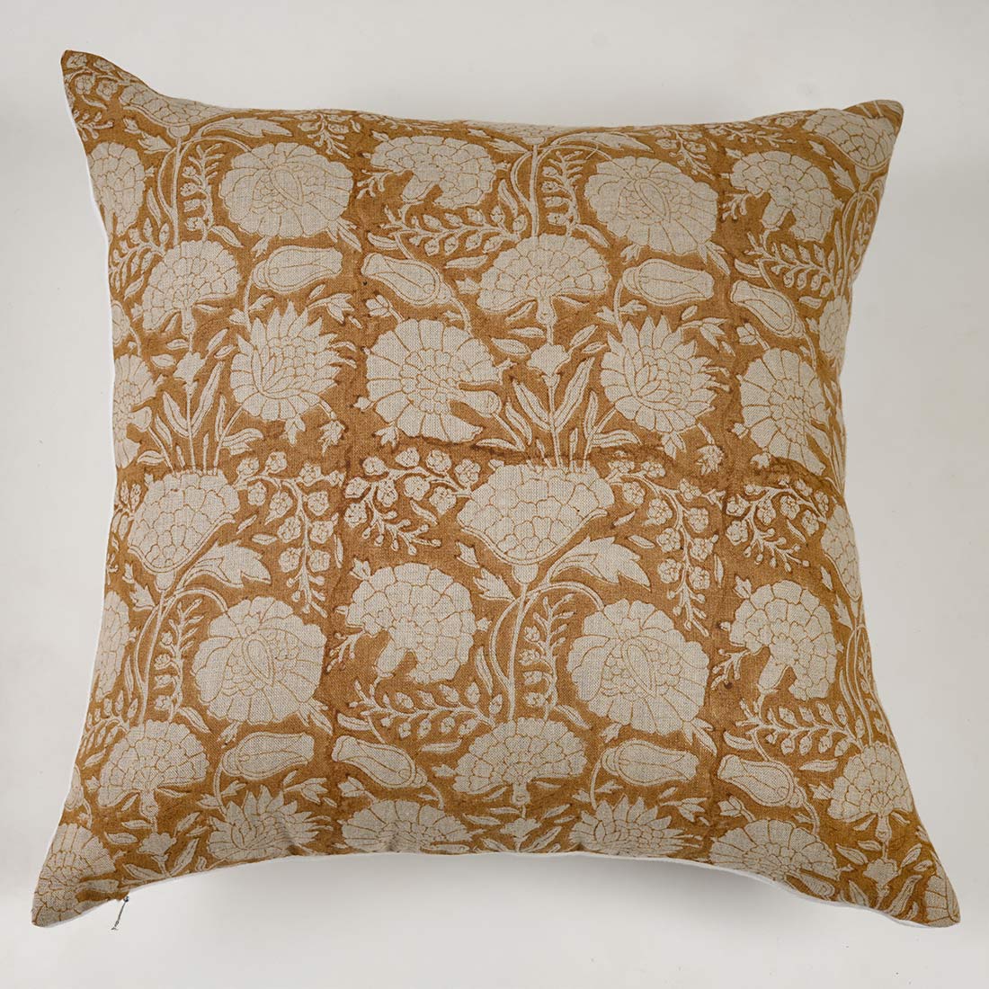 Decorative pillow with floral pattern on a yellow background