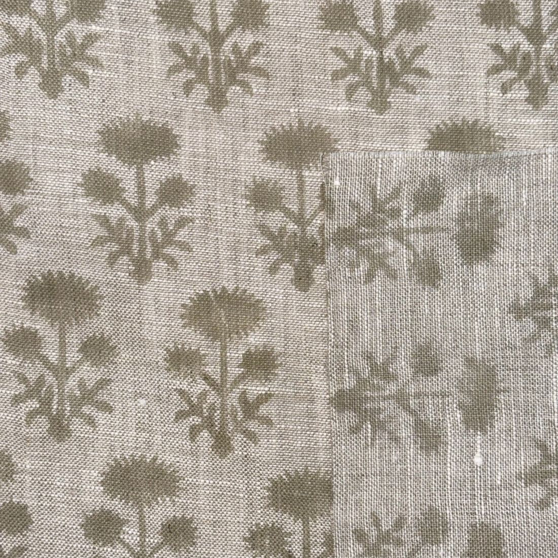Textile pattern with dark green leaves on a light gray background