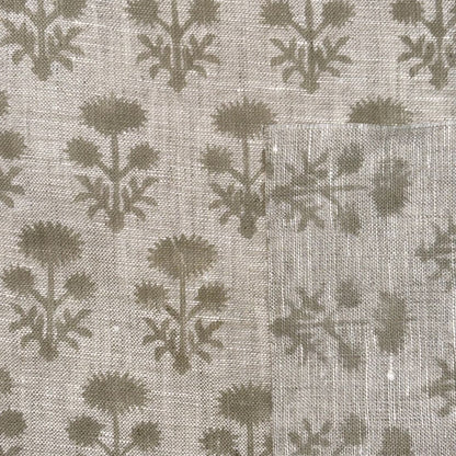 Textile pattern with dark green leaves on a light gray background