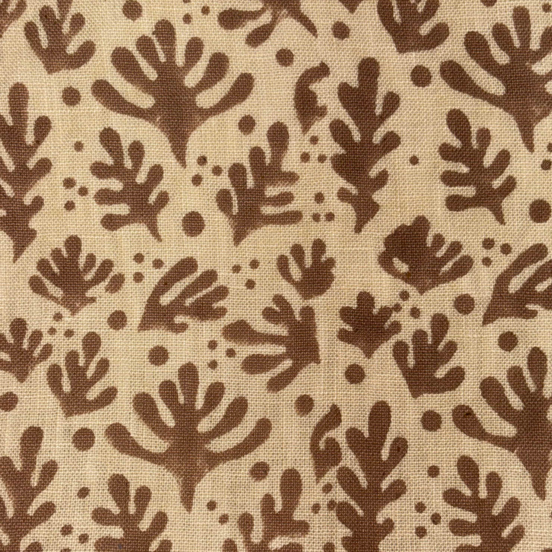 Brown leaf pattern on beige fabric background