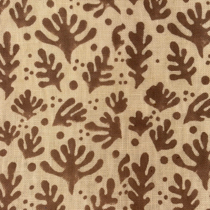 Brown leaf pattern on beige fabric background