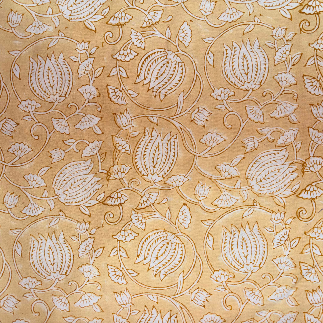 Decorative fabric pattern with white floral design on a beige background