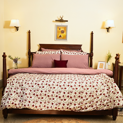 Bedroom with floral bedspread and wooden bed frame