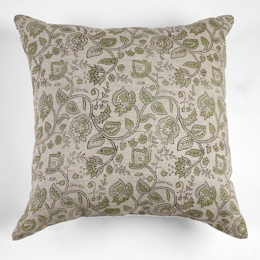 Decorative pillow with green floral pattern on a white background