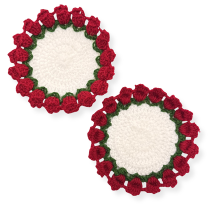 Two crocheted coasters with red floral patterns on a white background